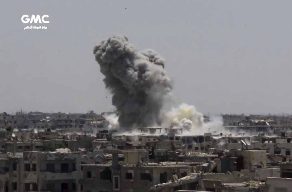 This frame grab from video provided on Sunday, Aug. 13, 2017, by the Ghouta Media Center, a Syrian activist media group, shows smoke and debris rising after Syrian government ground-to-ground rocketa strike the opposition-held town of Ain Terma, in the Eastern Ghouta suburb of Damascus, Syria on Saturday. (Ghouta Media Center, via AP)