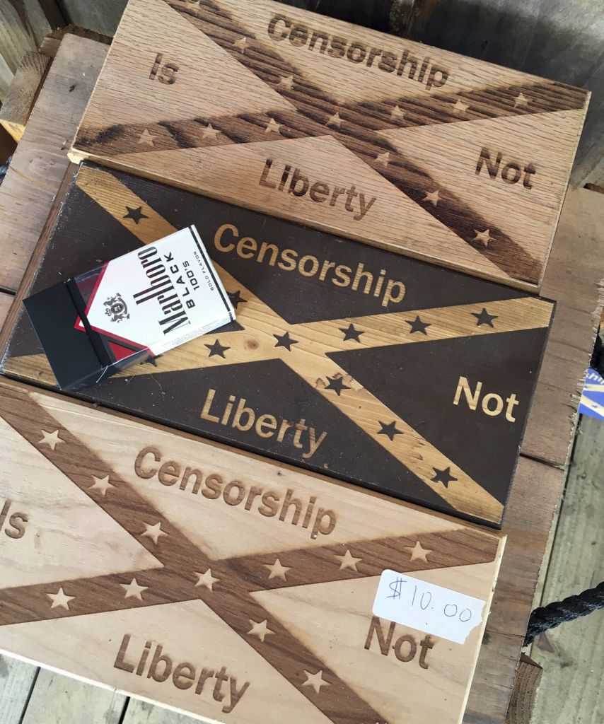 Confederate flag plaques emblazoned with the words "Censorship is not liberty" are shown on display at Dixie General Store in the community of Chulafinnee, Ala., on Thursday, Aug. 17, 2017. Store owner Robert Castello said he is worried about groups like neo-Nazis and the Ku Klux Klan becoming the fact of the debate over Confederate memorials. (AP Photo/Jay Reeves)
