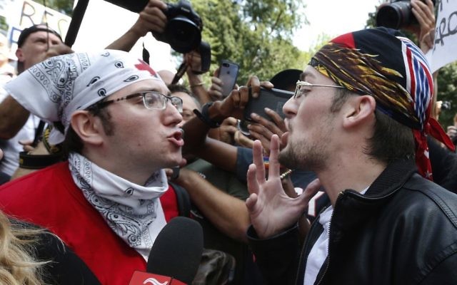 A professed supporter of President Donald Trump, center, argues with a counterprotester, left, at a "Free Speech" rally by conservative activists on Boston Common, Saturday, Aug. 19, 2017, in Boston. (AP Photo/Michael Dwyer)