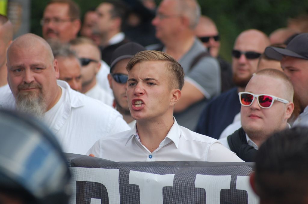 In this August 19, 2017 photo participants at a far-right protest commemorating the 30th anniversary of the death of leading Nazi figure Rudolf Hess rally in Berlin, Germany, on Saturday, August 19, 2017. (AP Photo/Frank Jordans)