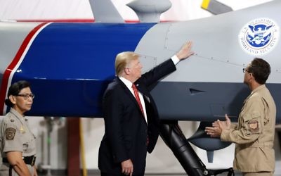 US President Donald Trump touches an unmanned aerial vehicle during a tour of US Customs and Border Protection Border equipment at their airport hanger at Marine Corps Air Station Yuma in Arizona, August 22, 2017. (AP Photo/Alex Brandon)