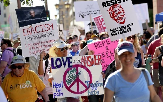 People protest outside the Phoenix Convention Center as US President Donald Trump holds a rally inside, August 22, 2017. (AP Photo/Matt York)