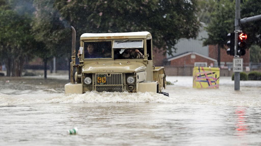 A truck pushes through floodwaters from Tropical Storm Harvey on Sunday, Aug. 27, 2017, in Houston, Texas. (AP Photo/David J. Phillip)