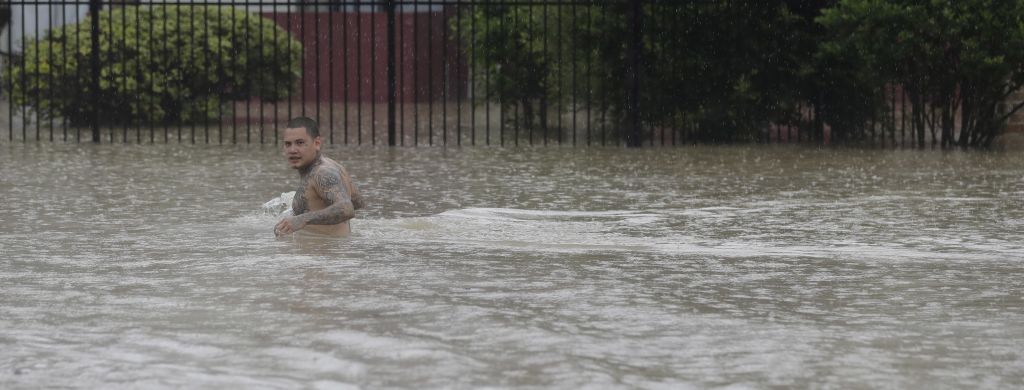 A man wades through floodwaters from Tropical Storm Harvey Sunday, Aug. 27, 2017, in Houston, Texas. (AP Photo/David J. Phillip) 