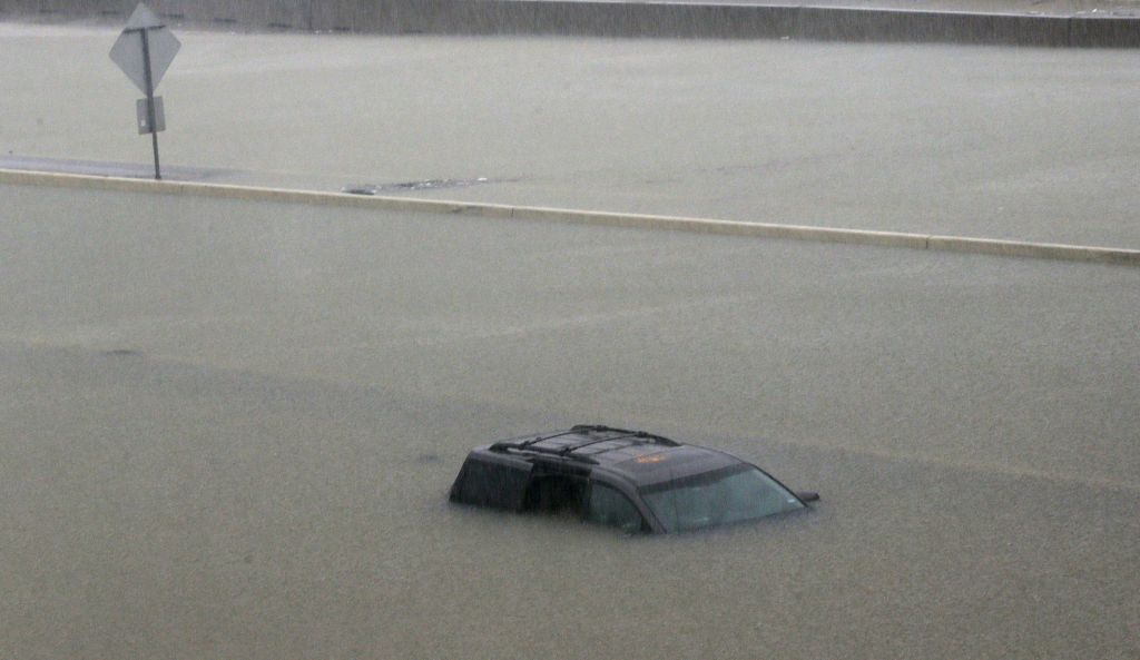 An abandoned vehicle sits in flood waters on the I-10 highway in Houston, Texas, Sunday, Aug. 27, 2017. (AP Photo/LM Otero)