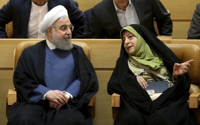 Iranian President Hassan Rouhani, left, listens to the Vice-President in charge of environmental affairs Masoomeh Ebtekar while attending a conference on combating sand and dust storms, in Tehran, Iran, Monday, July 3, 2017 (AP Photo/Vahid Salemi)