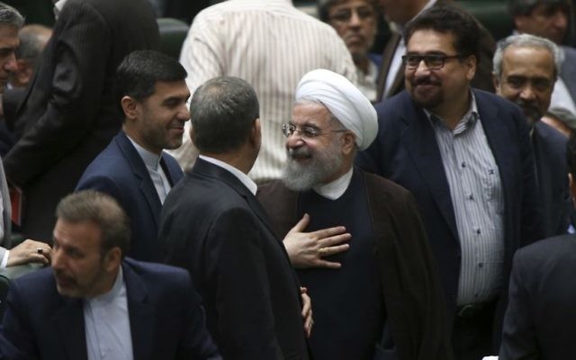 Iranian President Hassan Rouhani (C) leaves the parliament after proposing his new cabinet, in Tehran, Iran, August 15, 2017. (AP Photo/Vahid Salemi)