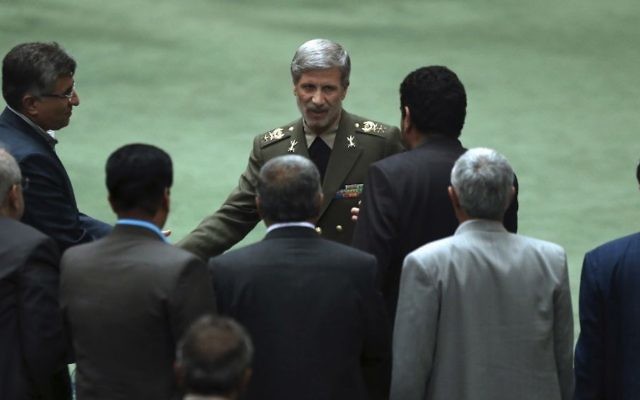 Nominee for the post of defense minister for new cabinet of Iranian President Hassan Rouhani, General Amir Hatami (C) is greeted by a group of lawmakers after delivering his speech in a session of parliament in Tehran, Iran August 17, 2017. (AP Photo/Vahid Salemi)
