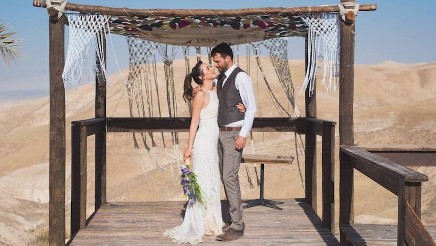 Shani and Ran Maaman embracing under the huppah at their wedding, May 11, 2017. (Dana Bar-On/JTA)