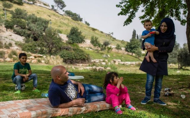 Illustrative: A family enjoys a picnic in the grass, near the East Jerusalem neighborhood of Abu Tur on April 8, 2016.  (Corinna Kern/FLASH90)