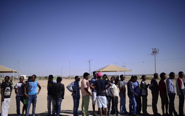 African asylum seekers gather at the entrance to Holot Detention Center in southern Israel to mark the International Refugees Day on Saturday, June 18, 2016. (Tomer Neuberg/Flash90)