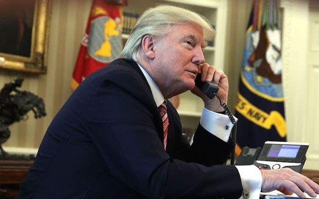 US President Donald Trump speaking on the phone in the Oval Office on June 27, 2017. (Alex Wong/Getty Images)