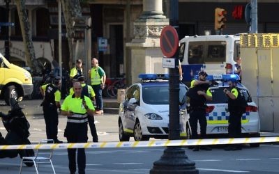 Medical staff members and policemen standing in a cordoned-off area after a van ploughed into the crowd on the Las Ramblas Boulevard in Barcelona, Spain, on August 17, 2017. (Josep Lago/AFP/Getty Images) 