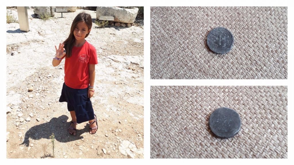 8-year-old Hallel Halevy holding her find of a rare 2,00-year-old half-shekel coin on August 23, 2017 in Halamish. (courtesy)