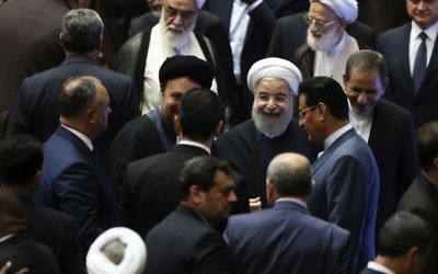Iran's President Hasan Rouhani, center, leaves the parliament at the end of his swearing-in ceremony for the second term in office, in Tehran, Iran, Saturday, Aug. 5, 2017. (AP Photo/Ebrahim Noroozi)