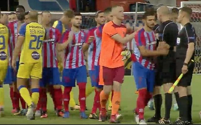 Players from Israel's Maccabi Tel Aviv soccer team great their counterparts from Greece's Panionios ahead of their soccer match in Greece on August 3, 2017. (Screen capture: YouTube)
