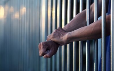 Illustrative: A prisoner behind bars. (sakhorn38/ iStock via Getty images)