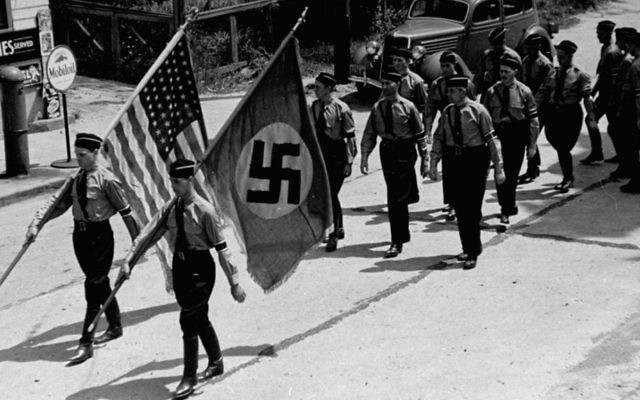 During the 1930s in Yaphank, New York, members of the Nazi party march through the Long Island town, where they also organized a pro-Hitler summer camp (Public domain)