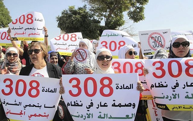 Women activists in front of Jordan's parliament in Amman call on legislators to repeal a provision that allows a rapist to escape punishment if he marries his victim. (AP Photo/Reem Saad)