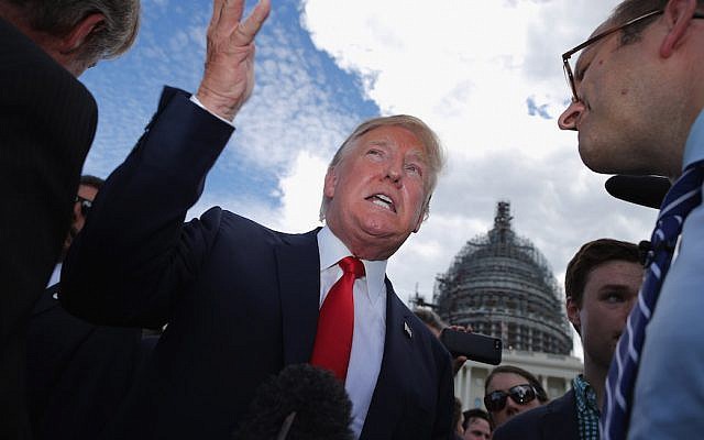 Then-presidential candidate Donald Trump speaks with journalists at a rally against the Iran nuclear deal at the US Capitol, September 9, 2015. (Chip Somodevilla/Getty Images via JTA)