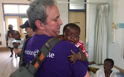 Dr. Omri Emody with a patient in Ghana (Courtesy)