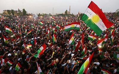 Iraqi Kurds fly Kurdish flags during an event to urge people to vote in the upcoming independence referendum in Arbil, the capital of the autonomous Kurdish region of northern Iraq, on September 16, 2017. (AFP/Safin Hamed)