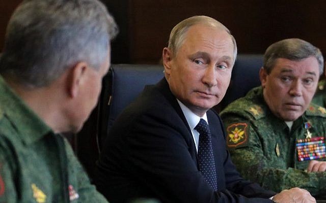 Russian President Vladimir Putin (C), accompanied by Defence Minister Sergei Shoigu (L) and Chief of the General Staff Valery Gerasimov (R), watches the joint Zapad-2017 (West-2017) Russian military exercises with Belarus at the Luzhsky training ground in the Leningrad region on September 18, 2017. (AFP/Sputnik/Mikhail Klimentyev)