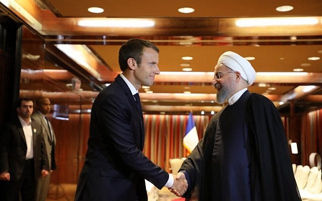 France's President Emmanuel Macron (L) greets Iranian President Hassan Rouhani at the Millennium Hotel in New York on September 18, 2017, in New York. (AFP Photo/Ludovic Marin)