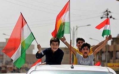 Iraqis Kurds celebrate with the Kurdish flag in the streets of the northern city of Kirkuk on September 25, 2017, as they vote in a referendum on independence. (AFP PHOTO/ AHMAD AL-RUBAYE)