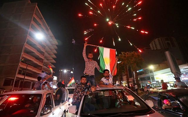 Iraqi Kurds wave the Kurdish flag as they celebrate in the streets of the northern city of Irbil on September 25, 2017, following a referendum on independence. (AFP/Safin Hamed)