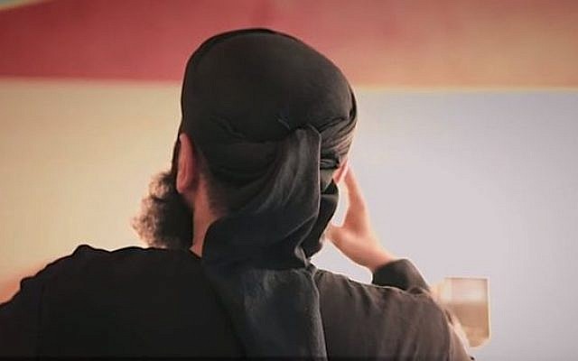 Notorious hate preacher Abu Walaa showing his back in an online video, as has become his trademark. (Screen capture: YouTube)