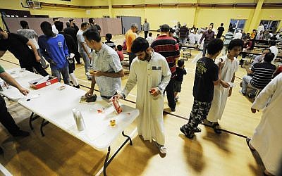 In this Thursday, Aug. 31, 2017, photo, Muslims at Champions Mosque gather for a meal at an Islamic holy day celebration. (AP Photo/Jay Reeves)