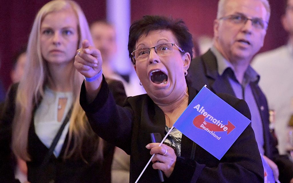 Guests at an Alternative for Germany party, AfD election party react to the first projections for the German election in Erfurt, Germany, September 24, 2017. (Martin Schutt/dpa via AP)