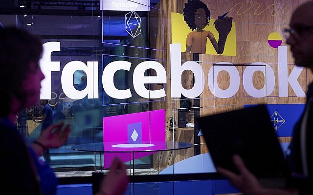 In this Tuesday, April 18, 2017, file photo, conference workers speak in front of a demo booth at Facebook's annual F8 developer conference, in San Jose, California. (AP/Noah Berger)