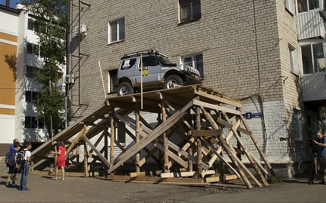 A car is parked at a ramp leading up to the window of a Soviet-era apartment in Birobidzhan, Russia, on Wednesday, Sept. 6, 2017. (AP/Iuliia Subbotovska)