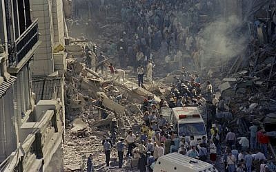 Firemen and rescue workers walk through the debris of Israel’s Embassy after a terrorist attack in Buenos Aires, Argentina, March 17, 1992. (AP Photo/Don Rypka)