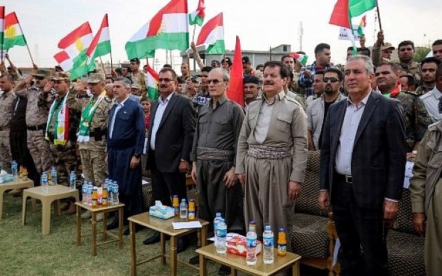 Kirkuk's provincial governor Najim al-Din Karim (3rd-R), who was sacked by the Iraqi parliament the previous week, attends a rally in support of the upcoming independence referendum in Kirkuk on September 19, 2017, accompanied by the former speaker of the Kurdistan parliament and leading member of the Kurdistan Democratic Party, Kamal Kirkuki (2nd-R). (AFP PHOTO / Marwan IBRAHIM)