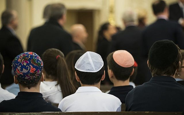 Illustrative: Children sitting at the Park East Synagogue, a Modern Orthodox congregation in New York City, March 3, 2017. (Drew Angerer/Getty Images, via JTA)