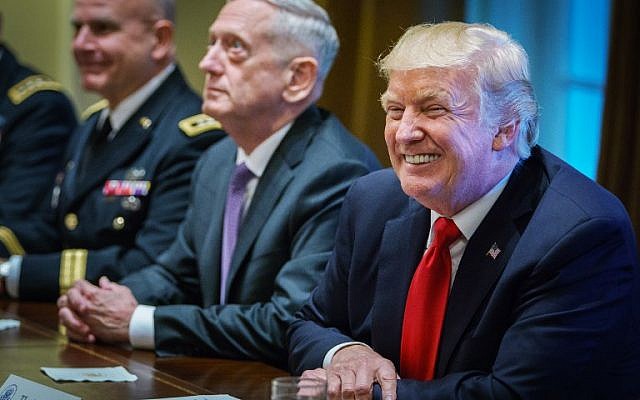 US President Donald Trump smiles as Defense Secretary James Mattis (C) looks on during a meeting with senior military leaders at the White House on October 5, 2017.(AFP Photo/Mandel Ngan)