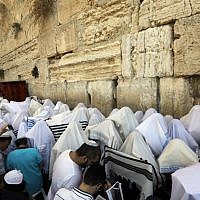 Jewish men perform the annual priestly blessing during the Sukkot holiday at the Western Wall in the Old City of Jerusalem on October 8, 2017. (AFP Photo/Menahem Kahana)