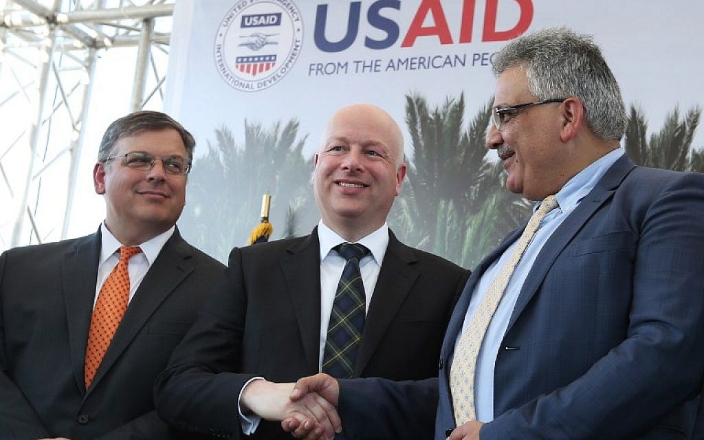 File: US special envoy Jason Greenblatt (C) shakes hands with Palestinian Water Authority chairman Mazen Ghunaim during the launch of a project to improve access to wastewater treatment and water for Palestinian farmers, on October 15, 2017, in the city of Jericho, in the West Bank. (AFP/Jaafar Ashtiyeh)
