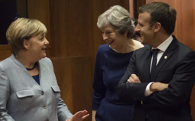 German Chancellor Angela Merkel, left, Britain Prime minister Theresa May, center, and French President Emmanuel Macron talk as they arrive in Brussels, on October 19, 2017.(AFP/JOHN THYS)