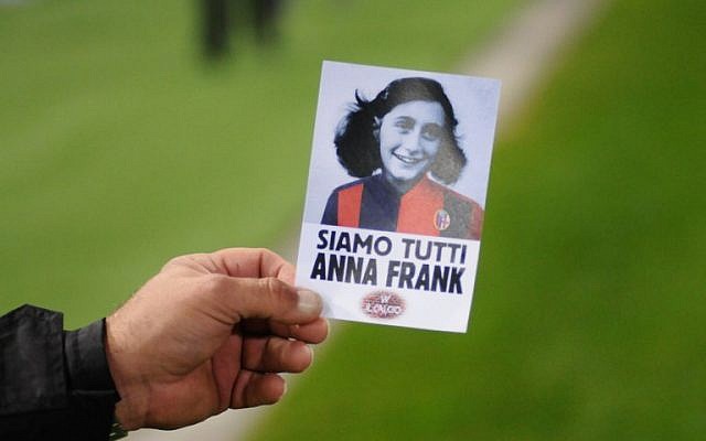An image of holocaust victim Anne Frank with reading "We are all Anne Frank," prior the Italian Serie A football match Bologna vs Lazio on October 25, 2017 at the Renato-Dall'Ara stadium in Bologna. (AFP PHOTO / Gianni SCHICCHI)