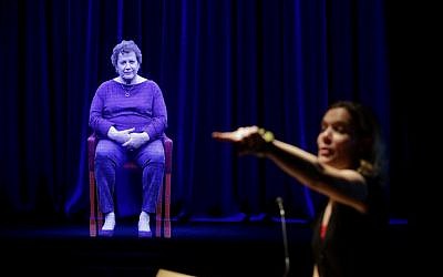 Amanda Friedeman takes a question from a student directed to Holocaust survivor Adina Sella, as she is displayed as a three-dimensional hologram at the Take A Stand Center in the Illinois Holocaust Museum and Education Center on October 26, 2017, in Skokie, Illinois. (Joshua Lott/AFP)