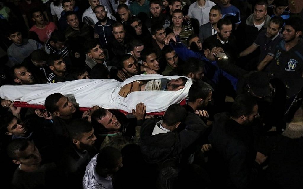 The body of Marwan Alagha, 22, is carried by mourners after he was killed when Israel blew up a tunnel built by the Islamic Jihad terror group stretching from the Gaza Strip into its territory, at Naser hospital in Khan Yunis, in the southern Gaza Strip, on October 30, 2017.  (SAID KHATIB / AFP)