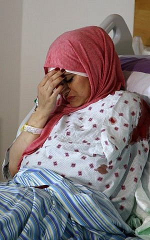 Latifa Musa, who was shot by IDF soldiers near the West Bank settlement of Halamish while in a car with her brother, is seen at a hospital in the West Bank city of Ramallah on October 31, 2017. (AFP Photo/Abbas Momani)