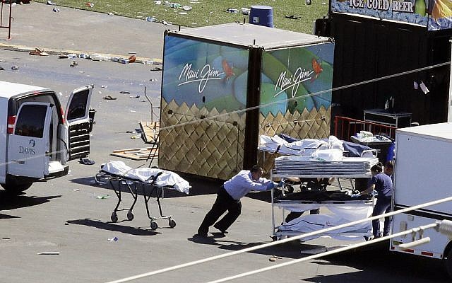 Investigators load bodies from the scene of a mass shooting at the Route 91 Harvest festival near the Mandalay Bay resort and casino on the Las Vegas Strip on in Las Vegas,  October 2, 2017. (AP/Chris Carlson)