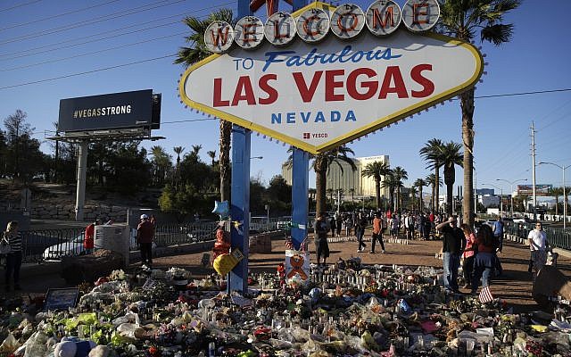 Flowers, candles and other items surround the famous Las Vegas sign at a makeshift memorial for victims of a mass shooting in Las Vegas, October 9, 2017. (AP/John Locher)