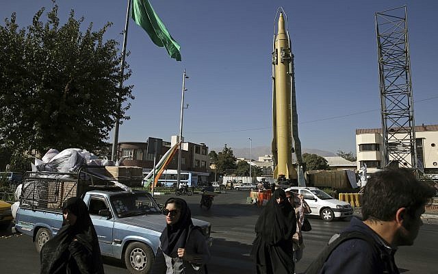 Iranians walk past a Ghadr-F missile displayed at a Revolutionary Guard hardware exhibition, marking 36th anniversary of the outset of Iran-Iraq war, at Baharestan Sq. in downtown Tehran, Iran, September 25, 2016. (AP/Vahid Salemi, File)