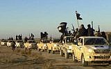 In this undated file photo, militants of the Islamic State group hold up their weapons and wave its flags on their vehicles in a convoy to Iraq, in Raqqa, Syria. (Militant website via AP, File)
